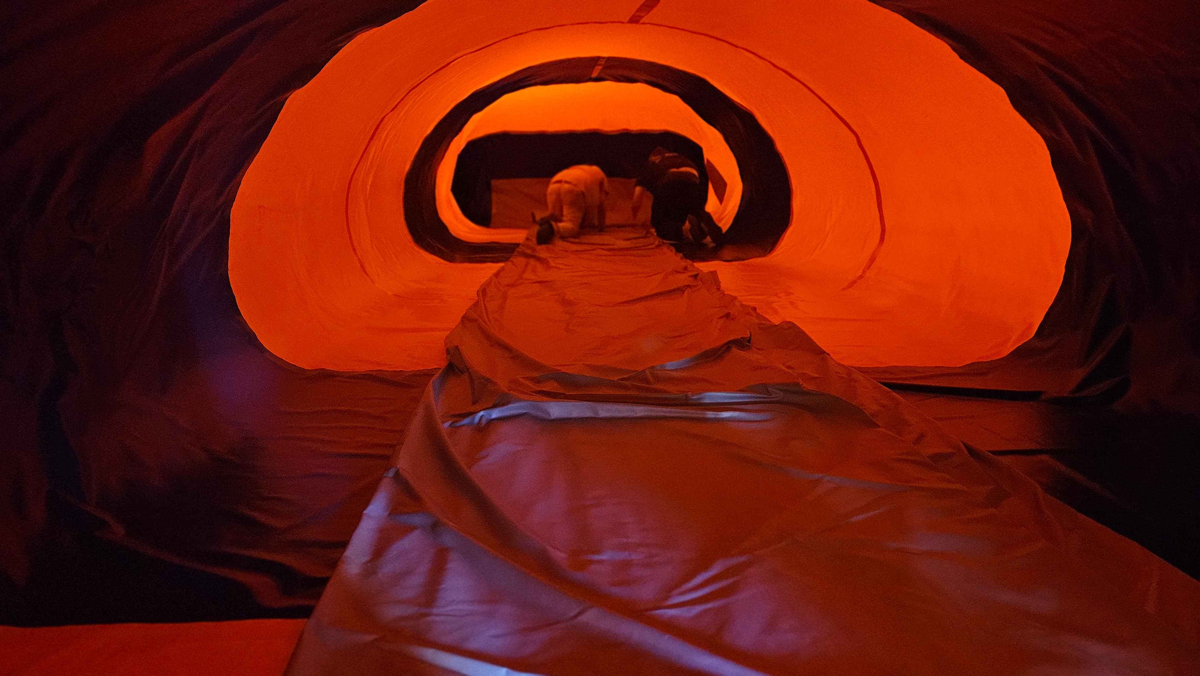 Gray Water Blob bladder being guided into the orange and black shell